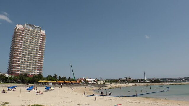 CHATAN-CHO, OKINAWA, JAPAN - AUGUST 2021 : View of Chatan sunset beach (Ocean or sea). Wide view, time lapse shot in daytime. Summer holiday, vacation and resort concept video.