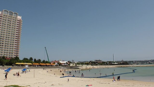 CHATAN-CHO, OKINAWA, JAPAN - AUGUST 2021 : View of Chatan sunset beach (Ocean or sea). Wide view, time lapse shot in daytime. Summer holiday, vacation and resort concept video.