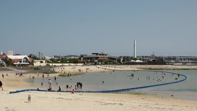 CHATAN-CHO, OKINAWA, JAPAN - AUGUST 2021 : View of Chatan sunset beach (Ocean or sea). Wide view, time lapse shot in daytime. Summer holiday, vacation and resort concept video.