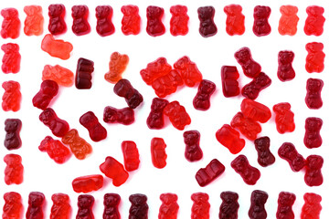 Small gummy bears red and brown on a white background