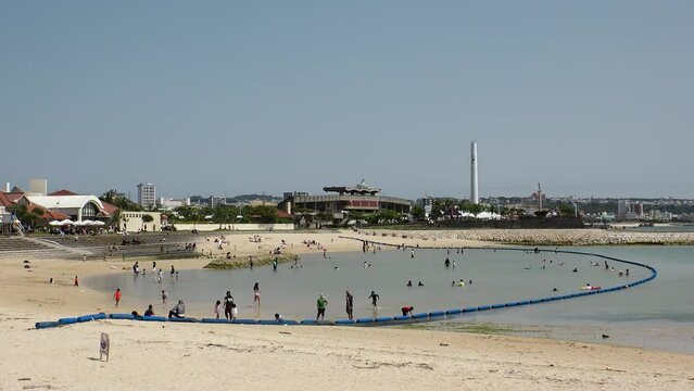 CHATAN-CHO, OKINAWA, JAPAN - AUGUST 2021 : View of Chatan sunset beach (Ocean or sea). Wide view, time lapse shot in daytime. Summer holiday, vacation and resort concept video.