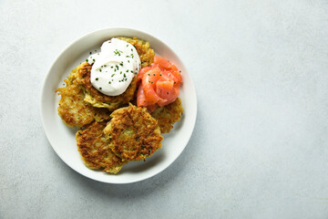 Homemade potato pancakes or lakes with salmon