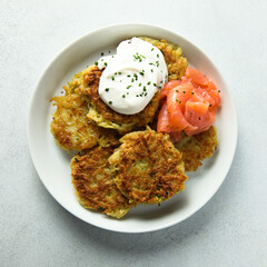 Homemade potato pancakes or lakes with salmon