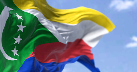 Detail of the national flag of Comoros waving in the wind on a clear day.