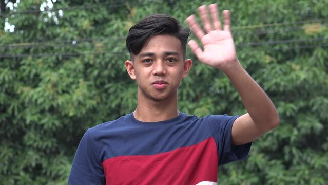 An Asian Male Waving Goodbye