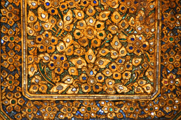 Golden Pattern at Wat Pho in Bangkok, Thailand with Floral Design of shapes and color. Vintage thai golden pattern with gems. Asian golden ornament in Thailand. Traditional decorative background