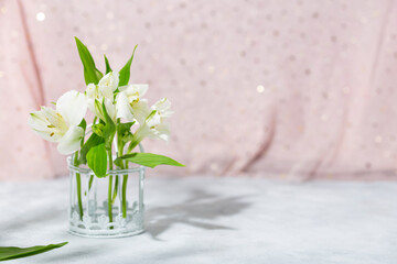 A bouquet of delicate white flowers. Festive card with spring flowers on a light pink background, photo with copy space for text