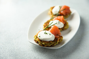 Homemade potato pancakes or lakes with salmon
