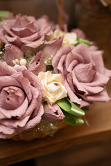 Basket with pink artificial flowers in the interior