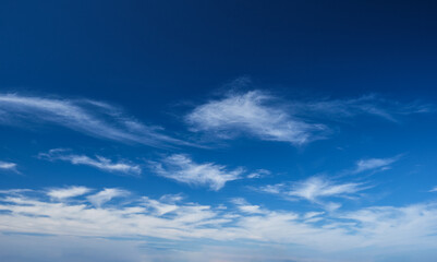 Naklejka na ściany i meble Blue clear sky with white cirrus spindrift clouds background