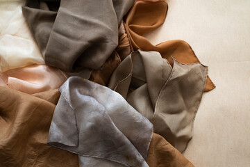 hand dyed clothes in warm natural tones hanging on a bright background - text space -
slow fashion concept 