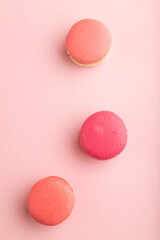 Magenta and pink macaroons on pink pastel background.  top view, close up.