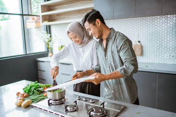 romantic young muslim couple have fun making food at home
