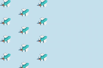 Trendy sunlight Summer pattern made with airplane figurine on bright light blue background. Minimal summer concept.