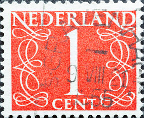 Netherlands - circa 1946: a postage stamp from the Netherlands , showing a numeral framed with ornaments. Text: 1 cent, red