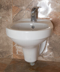 modern bidet washbasin in the toilet for the care and hygiene of intimate organs, close-up
