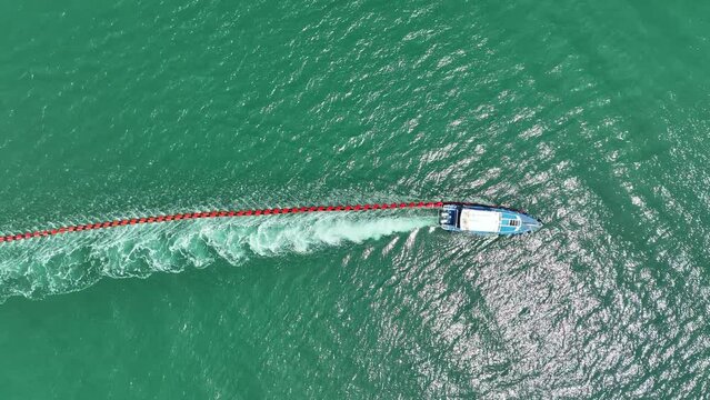 Sea float Buoyancy or spar buoy was dragged by speed boat sailing on the ocean