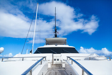 Frontal view of a luxury motor yacht, against a clear sky.