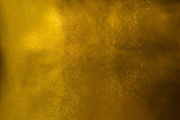 Golden metallic foil paper shiny abstract texture background