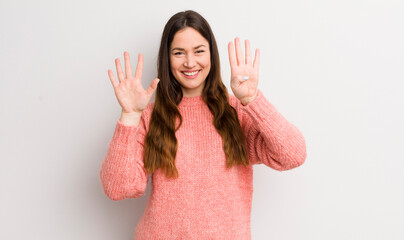 pretty caucasian woman smiling and looking friendly, showing number nine or ninth with hand...