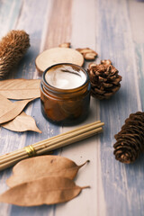 herbal cream cosmetic in a container on table,