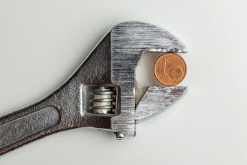 a coin clamped in a adjustable wrench