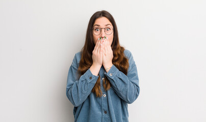 pretty caucasian woman happy and excited, surprised and amazed covering mouth with hands, giggling...