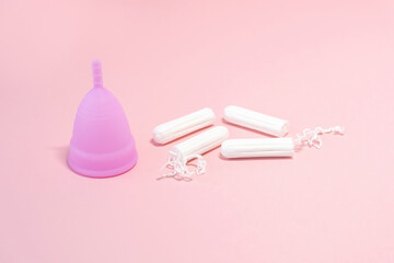 Menstrual cycle. Alternative means of hygiene and protection in critical days for women.Tampons or silicone menstrual cup on  pink background. Сoncept : reuse, eco, safety. Selective focus. 