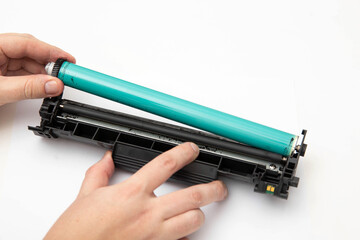 Removing and replacing the photoconductor from the printer cartridge. White background. Copy space...