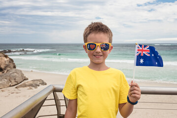 Boy holding Australian flag in his hand on Australia Day, Kangaroo Island, South Australia