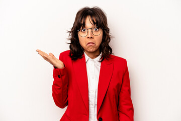 Young business hispanic woman isolated on white background shrugs shoulders and open eyes confused.