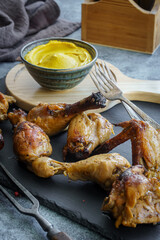 Grilled chicken drumsticks and wings with mustard sauce. Low shallow focus