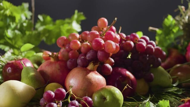 Zoom out of fruit assortment on the table. Basket of fruits. Dry fruits. Grape branches