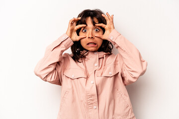 Young hispanic woman isolated on white background keeping eyes opened to find a success opportunity.