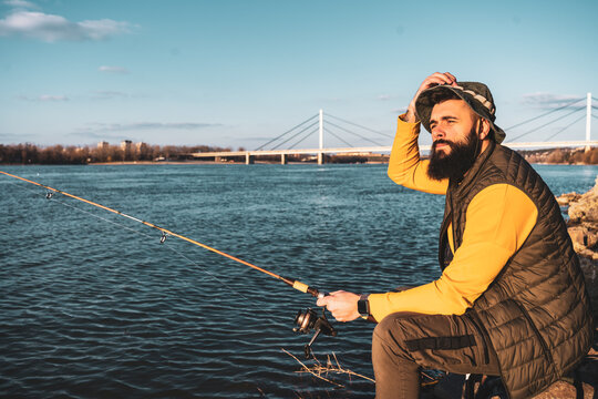 Man enjoys fishing by the river.