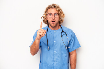 Young nurse caucasian man isolated on white background having an idea, inspiration concept.