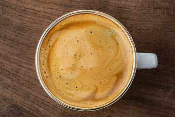 cup of espresso on wooden background top view
