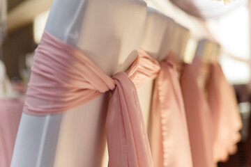 Obraz premium Beautiful pink and white wedding presidium for just married, arm-chairs with decorative fabric, close up shot