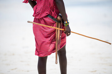 Zanzibar, Tanzania - January 02,2019: Masai warriors dressed in traditional clothes on sand beach...