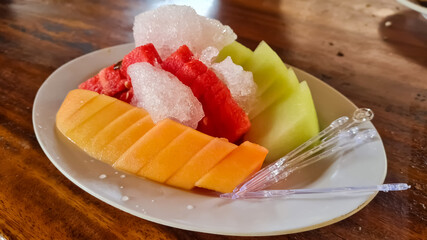 Fresh fruits background.Slices of fresh fruits on ice.