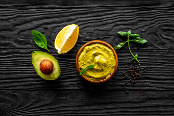 Obraz na płótnie Canvas Bowl of guacamole dip with avocado and lime. Homemade guacamole concept