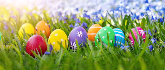 Easter eggs on the meadow with fresh green grass