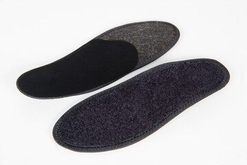 Black Insoles isolated on a white background. Medical orthopedic insoles. Foot care. Insole cutaway layers. Treatment and prevention of flat feet and foot diseases. Inner soles of shoes