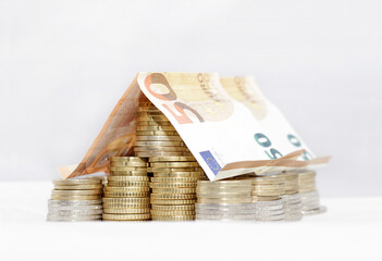 A house made out of Euro coins and bills: Mortgage, rent, investment