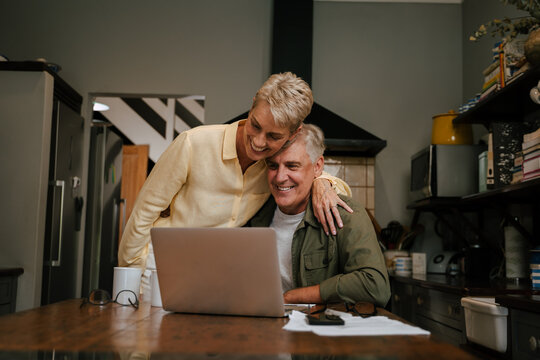 Happy Caucasian Senior Couple Working From Home