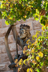 Bronze statue of King David playing the harp outside his tomb in the Old City of Jerusalem, Israel.