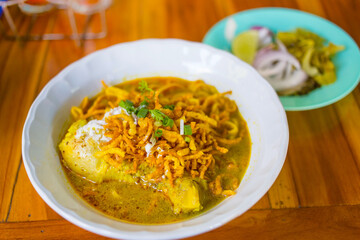 Northern Thai Curry Noodles with Chicken (Khao Soi Kai) is a traditional signature food of Northern of Thailand. Taste of soup has spicy and sweet while adds topping with crispy yellow noodle.