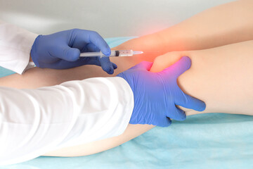 The doctor makes an injection of platelet-rich plasma, autostimulation of the regenerative...
