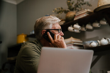 Caucasian elderly male on phone call stressed about work