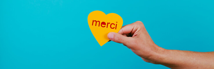 heart with text thank you in french, web banner